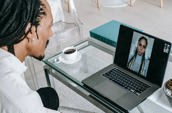 photo of a young black man on a computer video call with a young black woman