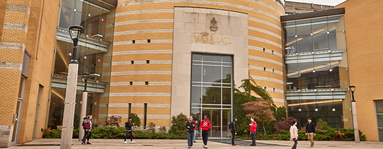 exterior view of Vari hall with students walking around