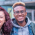 three students looking at the camera while smiling