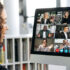 a woman views a virtual meeting on a computer screen